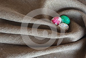 Easter eggs lie on sacking