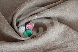 Easter eggs lie on sacking