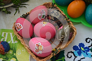 Easter eggs lie in a square basket.