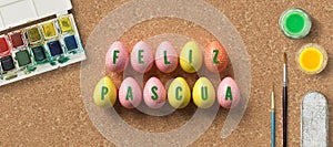 Easter eggs with message HAPPY EASTER in Spanish