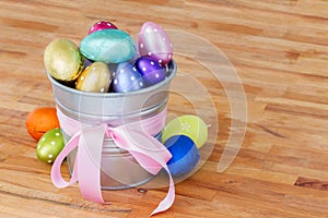 Easter eggs in metal pot on table