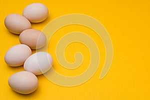 Easter eggs natural color on a yellow background with copyspace. easter advertise minimalist concept design