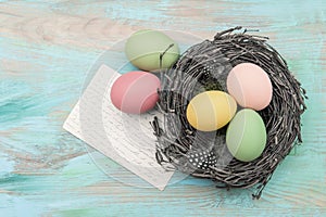 Easter eggs in nest and antique greetings card
