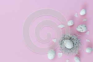 Easter eggs in nest on the pink background.Flat lay style.