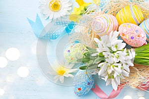 Easter eggs in the nest with spring flowers