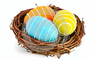 Easter eggs in a nest on a white background.