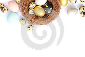 Easter eggs in a nest on a white background.Top view, copy space. Easter day.