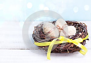 Easter eggs in nest wooden background empty space for text.