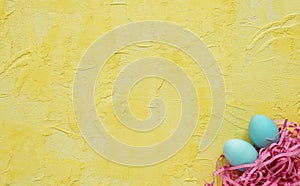 Easter eggs in the nest on yellow background.Easter concept.Copy space. photo
