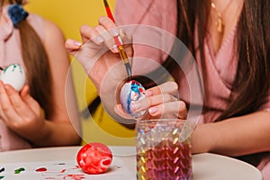 Easter eggs are painted close-up. A believing Christian family getting ready for the holiday