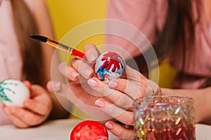 Easter eggs are painted close-up. A believing Christian family getting ready for the holiday