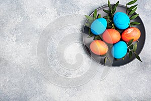 Easter eggs painted by hand colored on a concrete table, top view. copy space