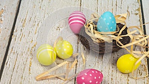 Easter eggs painted in pastel colors on white wooden background. Easter concept