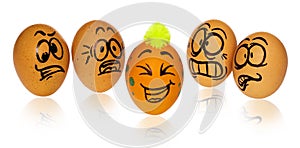 Easter eggs, painted in smiling and terrified cartoon faces look