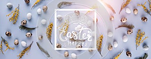 Easter eggs pattern background with spring flowers. Top view with copy space. Happy Easter card