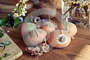 Easter eggs with plants attached to them with old nylons - preparation for dyeing with onion peels