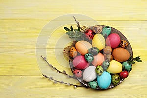 Easter eggs on a plate on a yellow background.Easter.