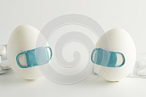 Easter eggs in a protective medicine mask on a white background. Quarantine Easter . Stop COVID-19 VIRUS.