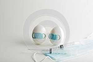 Easter eggs in a protective medicine mask on a white background. Quarantine Easter . Stop COVID-19 VIRUS.