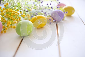 Easter eggs with spring blossom flowers on wooden background.