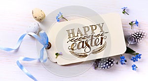 Easter eggs and spring flovers on wood background