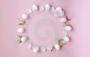 Easter Eggs with spring flowers petal on pink background concept copy space