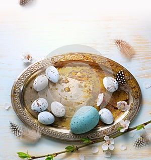 Easter Eggs with Spring Flowers on White Wooden Background
