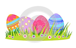 Easter eggs in spring grass and flowers