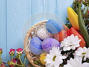 Easter eggs tulip flowers on blue wooden