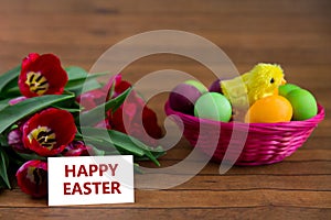 Easter eggs, tulips and card with copyspace