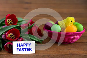 Easter eggs, tulips and card with copyspace