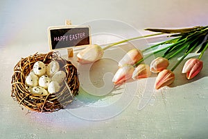 Easter eggs and tulips on wooden planks