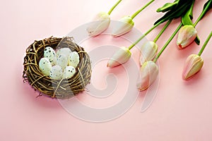 Easter eggs and tulips on wooden planks