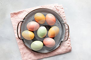 Easter eggs in vintage tray and one cracked egg in the middle