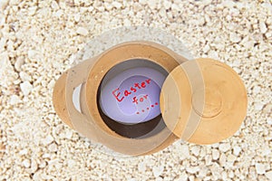 Easter eggs on white background, eggs colored clay pots