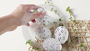 Easter eggs on a white background with flowers. Easter decor. white eggs with black pattern. beautiful easter decoring