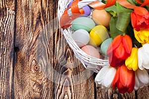 Easter Eggs in a white basket with colorful tulips