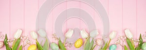 Easter eggs and white spring tulip flower bottom border against a pink wood banner background