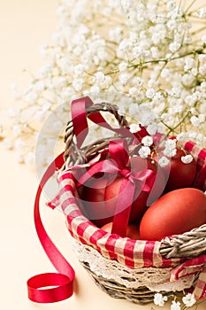 Easter eggs in the whitish nest and white flowers