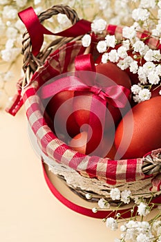 Easter eggs in the whitish nest and white flowers