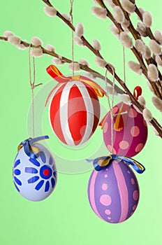 Easter eggs on willow bouquet, vertical over green