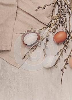 Easter eggs and willow branches on grey background, rustic style