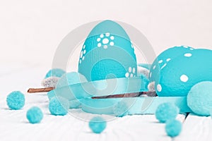 Easter eggs and willow branches on white background