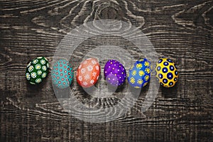 Easter eggs on wooden background In center. Top View