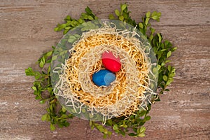 Easter eggs on a wooden background in the nest Situated on the middle