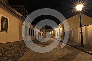 Easter European night city street paved road alley way long exposure landmark photography with old buildings and lantern