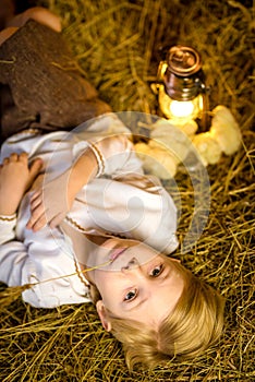 Easter fairy tale, a boy with chickens playing in a barn.