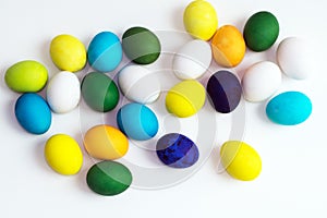 Easter festive colorful eggs on a white background. eggs yellow, blue, green and blue, orange