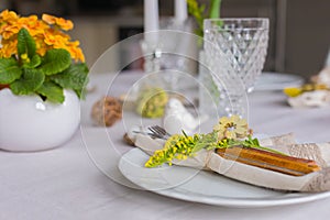 Easter festive spring table setting decoration, eggs in nest, selective focus, toned, top view