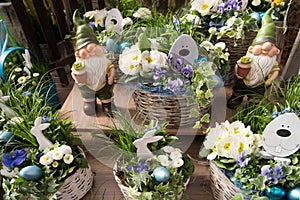 Easter flower arrangements with spring flowers for outside like white bellies, blue pansies, white primrose, bunnies and dwarfs.